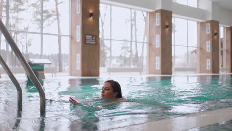 rest-in-modern-wellness-center-woman-is-swimming-in-indoor-pool-relax-in-spa-healthy-lifestyle-thermal-complex